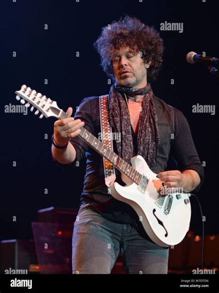 Doyle Bramhall II in a black shirt poses with ex-girlfriend Renee Zellweger.