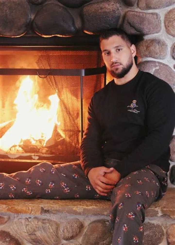 Luis Espina in a brown shirt poses for a picture