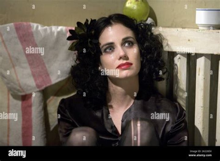 Mia Kirshner in a black t-shirt at an interview.