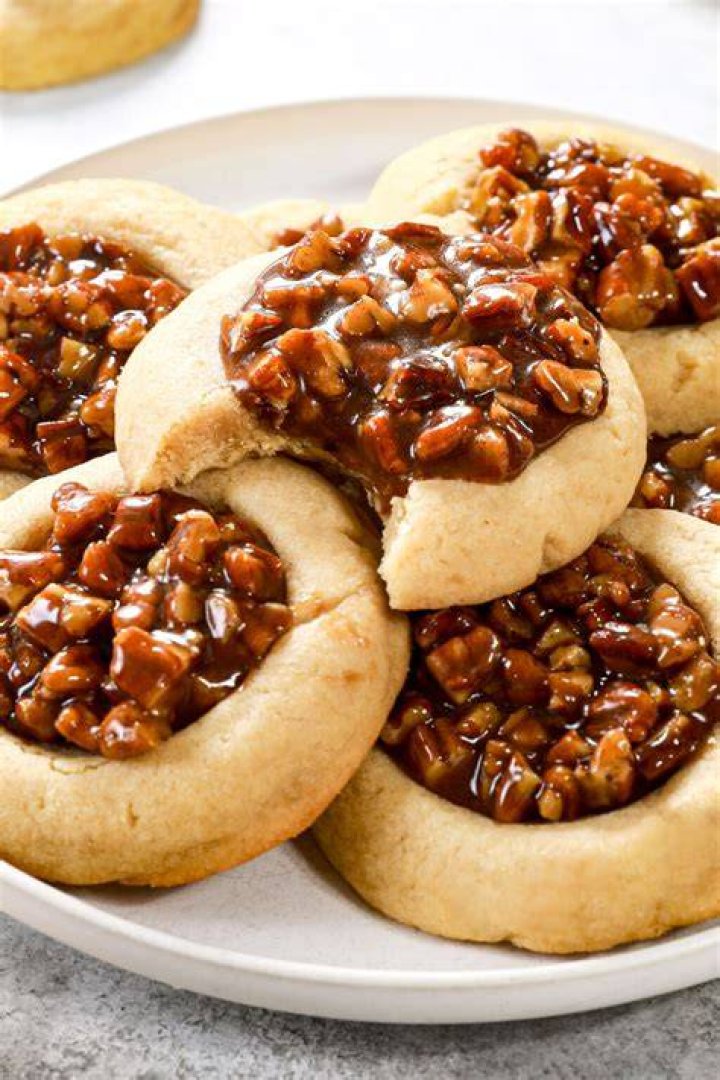 Pecan pie cookie with a bite taken out of it.