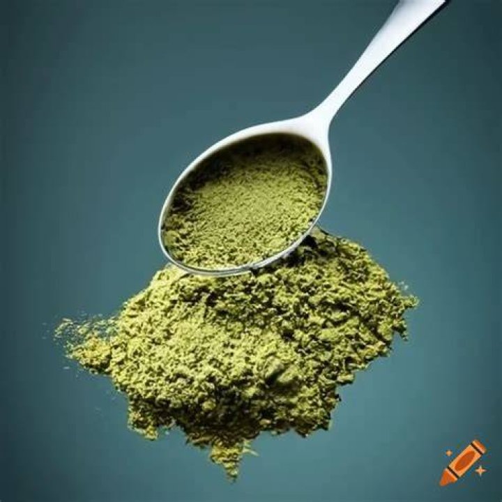 Tablespoon being pressed into a sugar cookie.