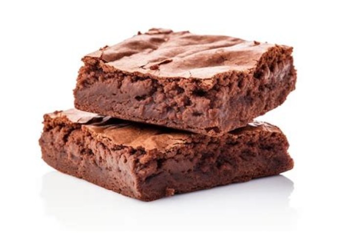 Two brownies on a white plate. 